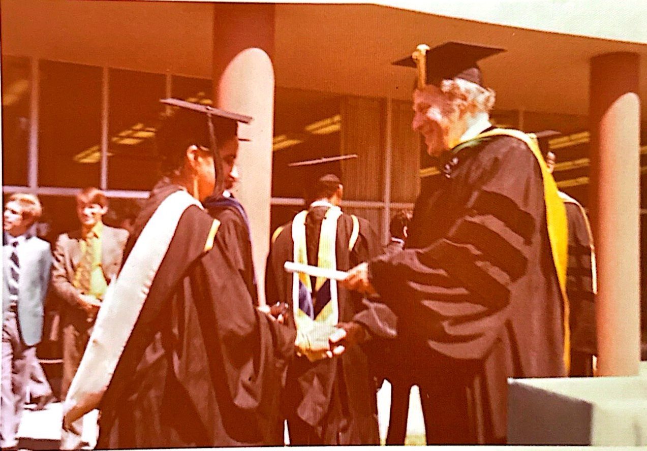 Dr. Rameshwari Sethi in cap and gown receiving her degree at an outdoor commencement