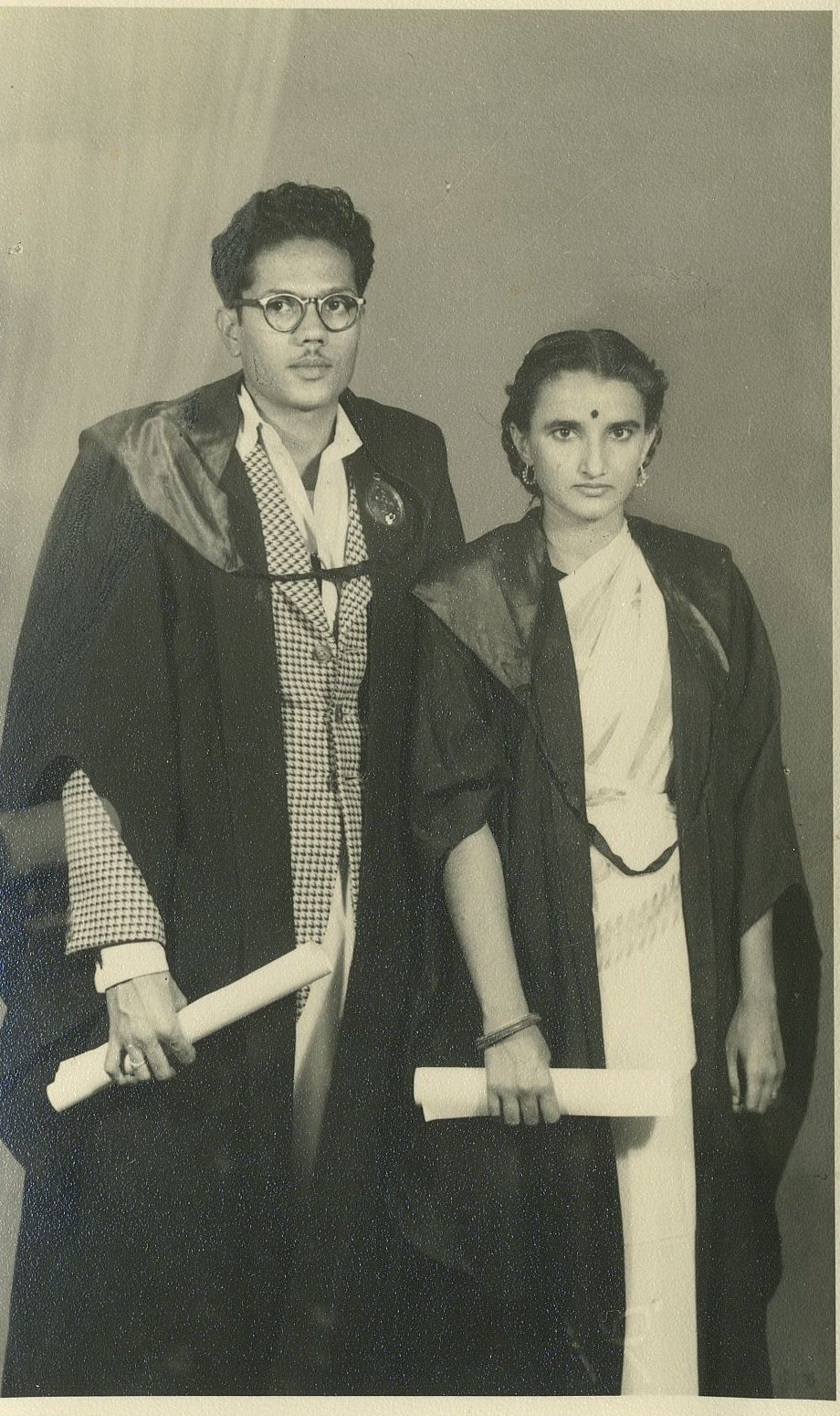 Dr. Jagat Prakash Sethi and Dr. Rameshwari Sethi in academic gowns holding their degrees